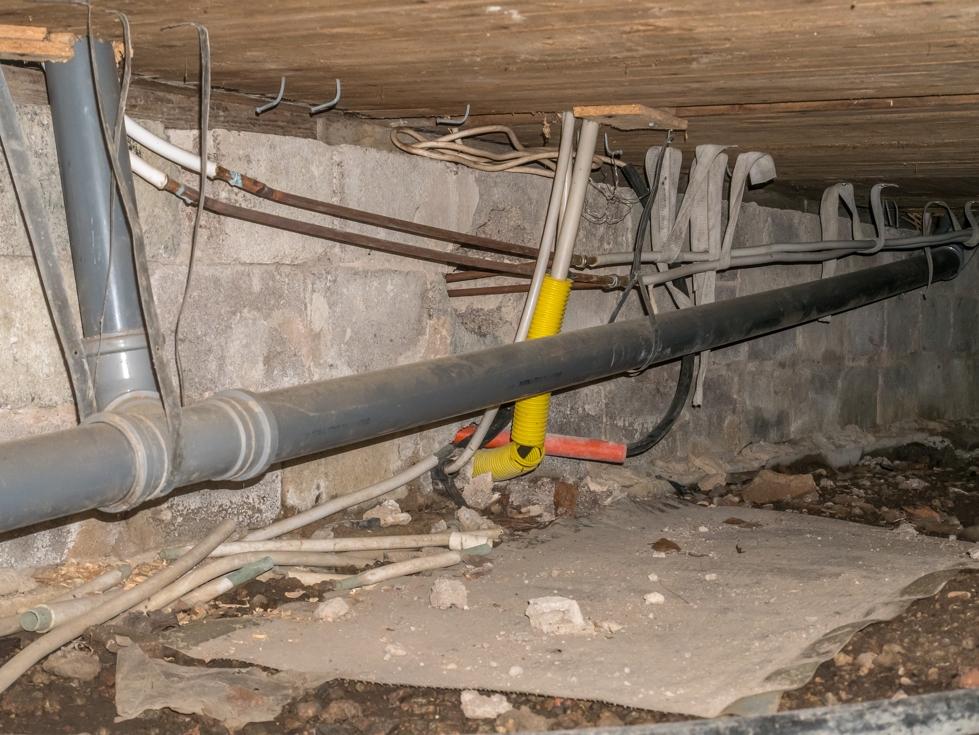 Basement crawl space with plumbing lines