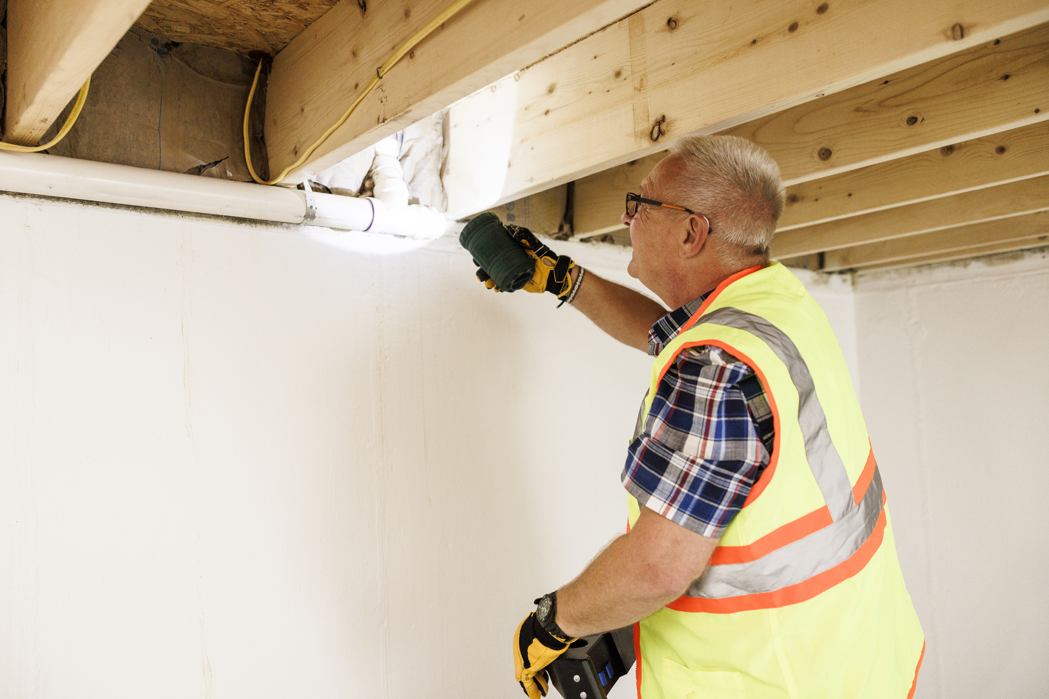 Man fixing pipes in basement