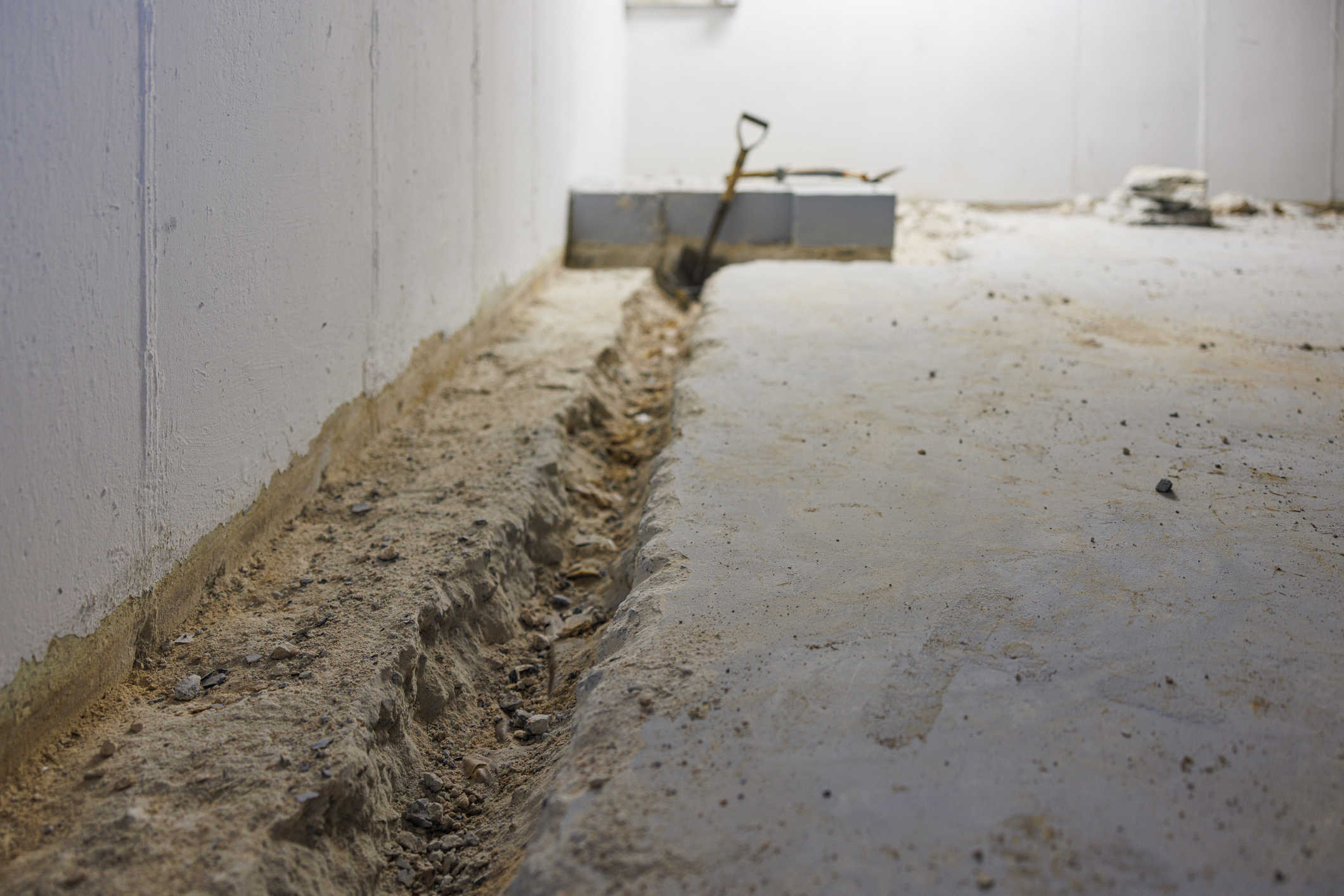 Shovel in concrete trench