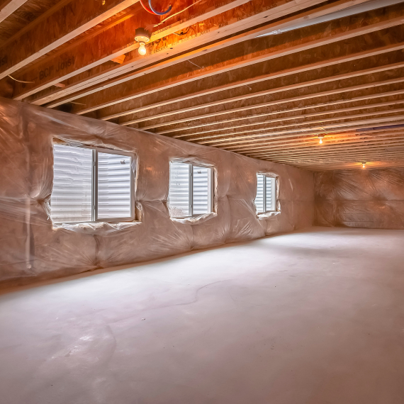 Empty basement with concrete floor and windows