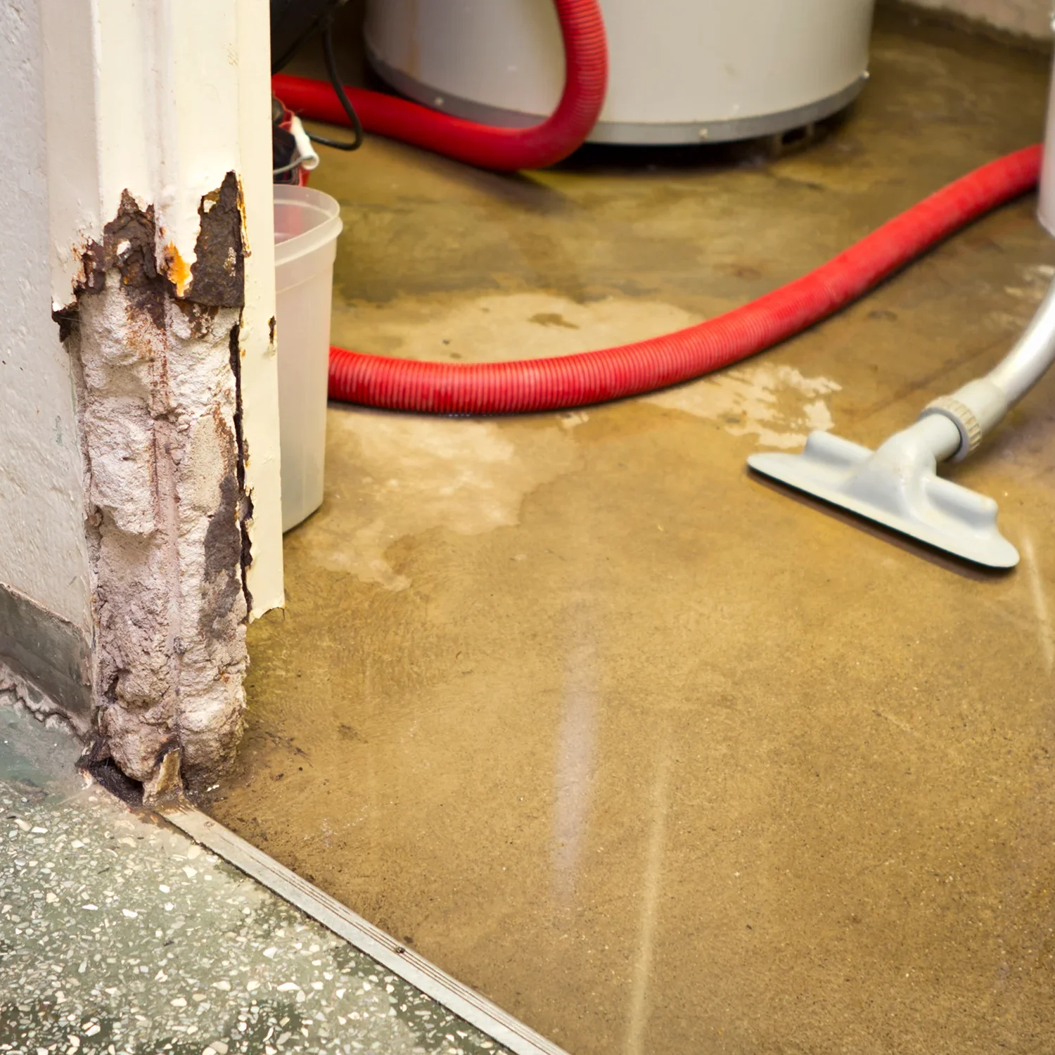 Water damage in a laundry room corner.